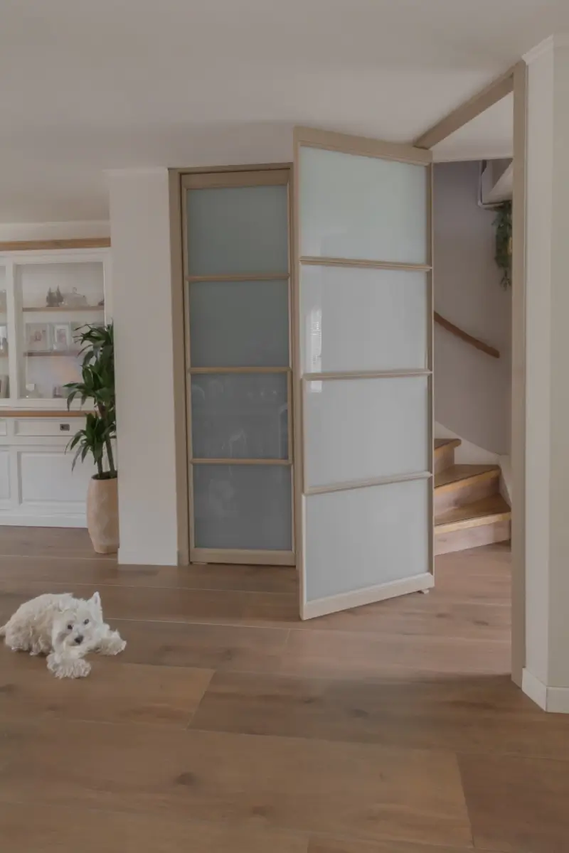 Woonkamer met vernieuwd stalen kozijn en stalen taatsdeur voor trap.